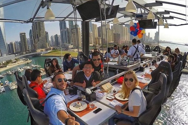 Dine 50 meters high with stunning views of Dubai's skyline and waterfront savoring a gourmet 3-course meal in an unforgettable sky dining experience surrounded by friends.